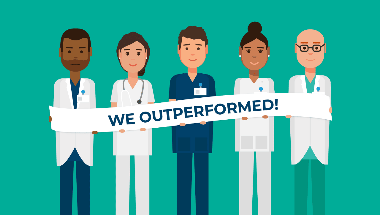 male and female OBGYN residents holding a banner that reads we outperformed